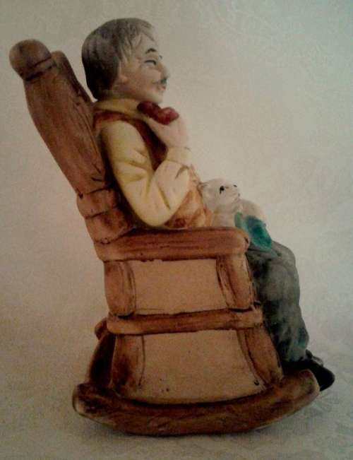 Two ornaments of and old couple on rocking chairs - lovely Pair.