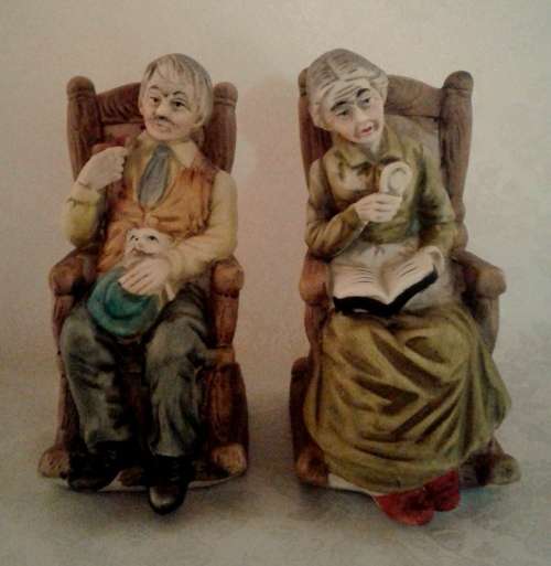Two ornaments of and old couple on rocking chairs - lovely Pair.
