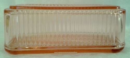 Vintage pink  glass refrigerator dish and lid.  Bottom is embossed with a vegetable pattern.