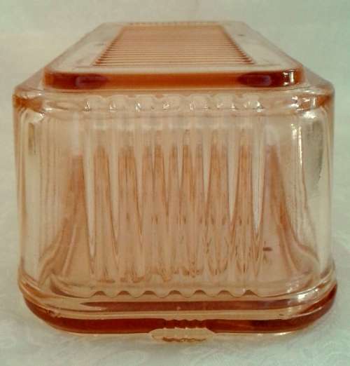 Vintage pink  glass refrigerator dish and lid.  Bottom is embossed with a vegetable pattern.