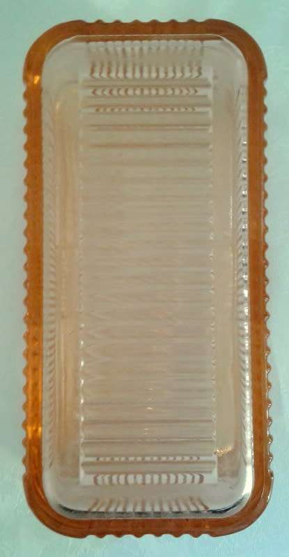 Vintage pink  glass refrigerator dish and lid.  Bottom is embossed with a vegetable pattern.