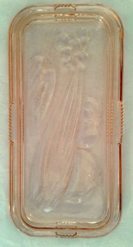 Vintage pink  glass refrigerator dish and lid.  Bottom is embossed with a vegetable pattern.