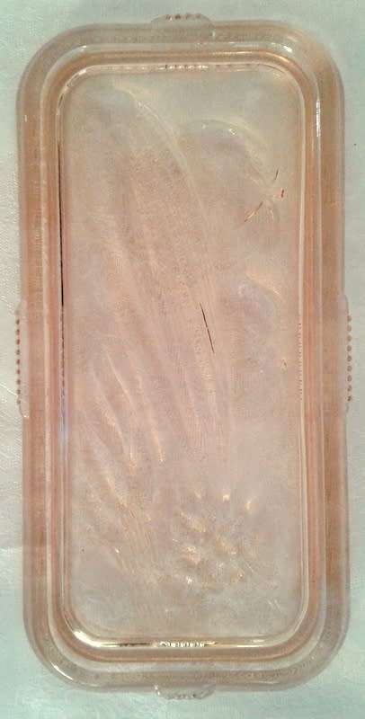 Vintage pink  glass refrigerator dish and lid.  Bottom is embossed with a vegetable pattern.
