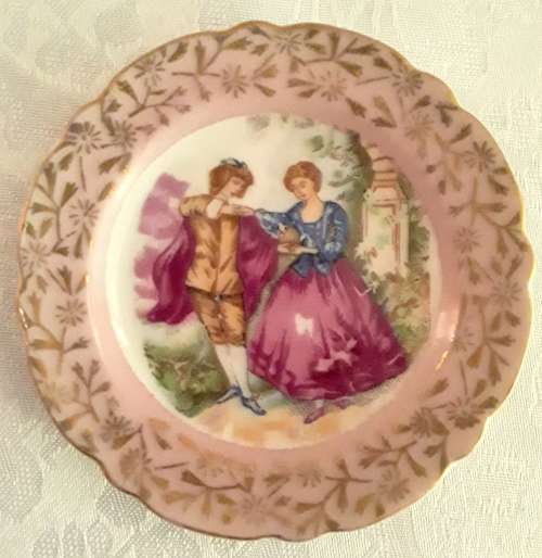 Two small miniature plates - pink with romantic scene