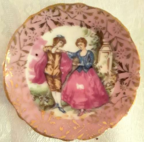 Two small miniature plates - pink with romantic scene