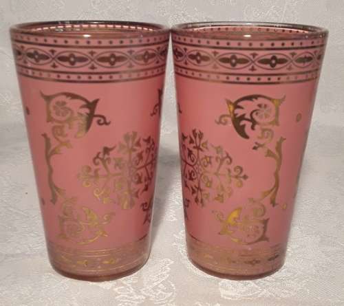 Two ornate glasses in pink and gold