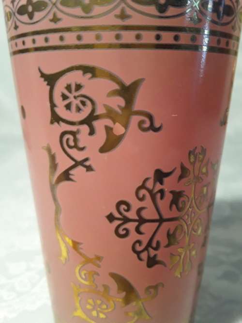 Two ornate glasses in pink and gold
