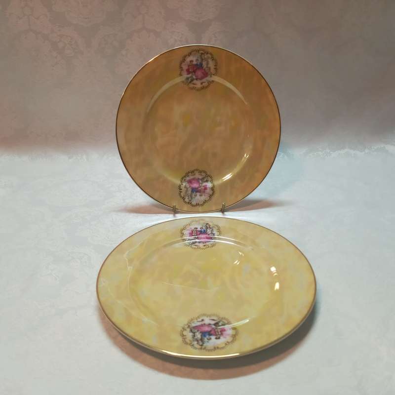 A pair of luster plates with romantic pictures
