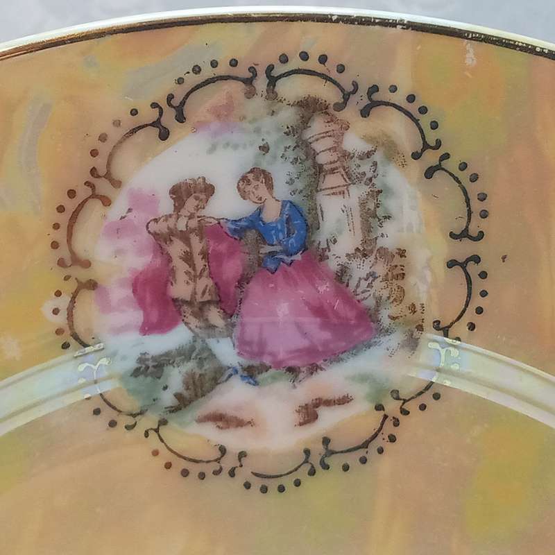 A pair of luster plates with romantic pictures