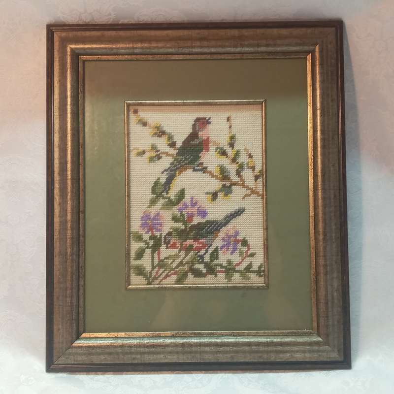Tapestry of birds and flowers, framed with a green background and wood frame