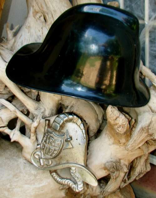 Good quality Fireman`s Carbon Helmet and a Cast iron Fire Chief Helmet sign
