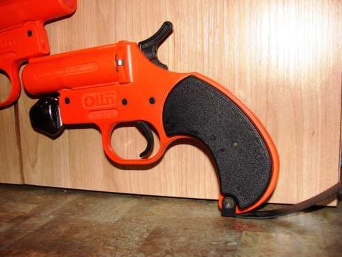 Two orange Olin 12 Gauge Flare Guns without flares (sell as a lot)