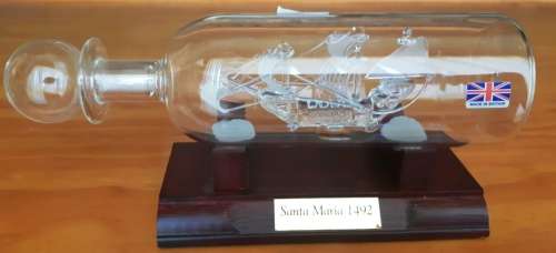 Santa Maria 1492 May Flower glass model ship in bottle on wooden stand-Made in Britain-good cond.