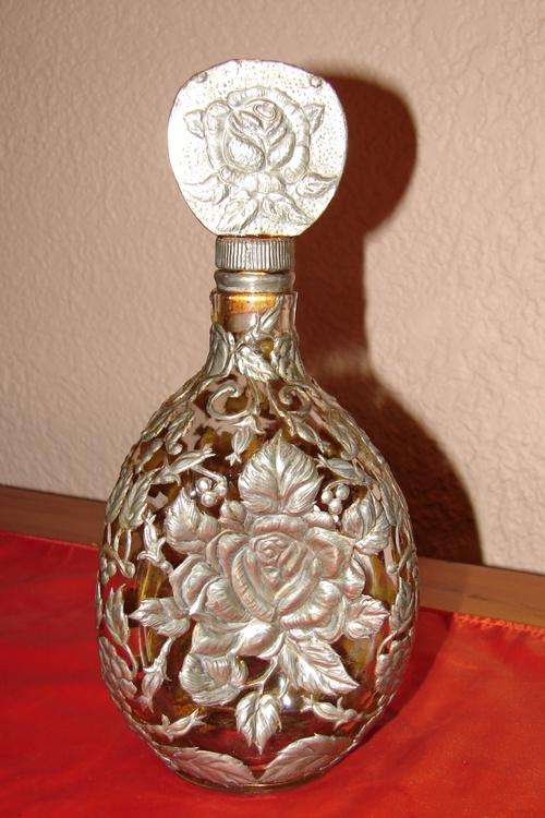 Stunning "Dimple Whisky" bottle decorated with pewter rose motif and cap - height 28cm