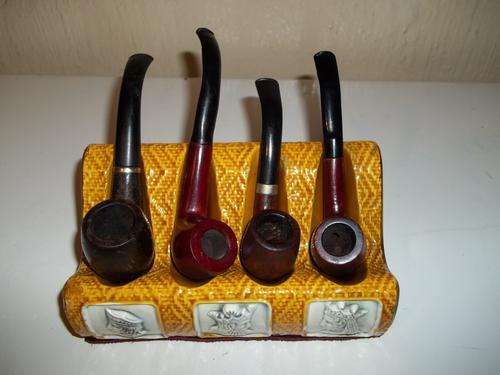 4 x old tobacco smoking pipes on a porcelain pipe stand