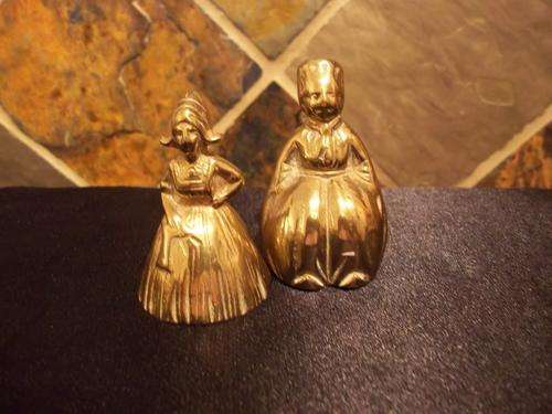 A PAIR OF BRASS BELLS DUTCH BOY AND GIRL