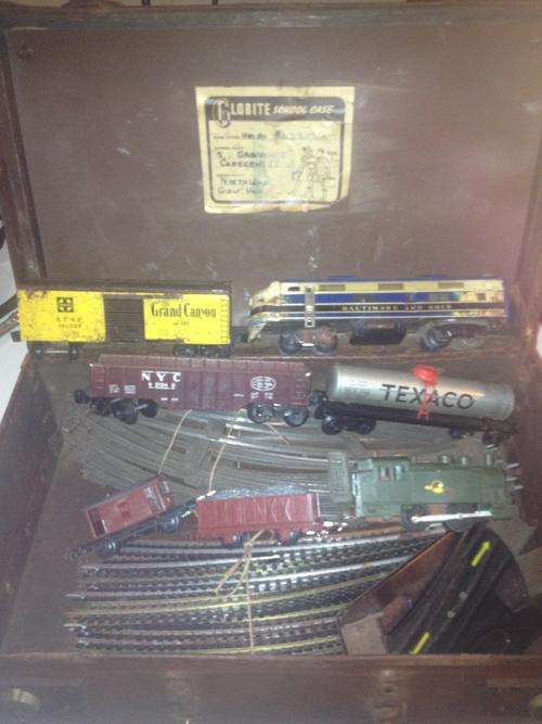 A suitcase lot of 2 old train sets and track