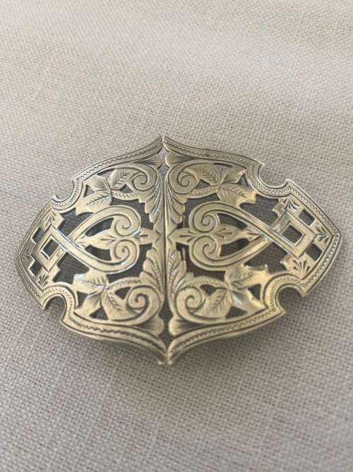 SILVER BUCKLE has markings anchor rampant with tail in air and a c
