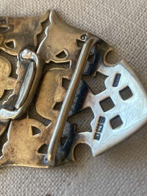 SILVER BUCKLE has markings anchor rampant with tail in air and a c