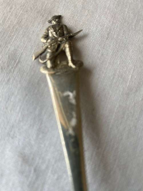SIVER SPOON WITH GUNNER AT TOP HAS MARKINGS