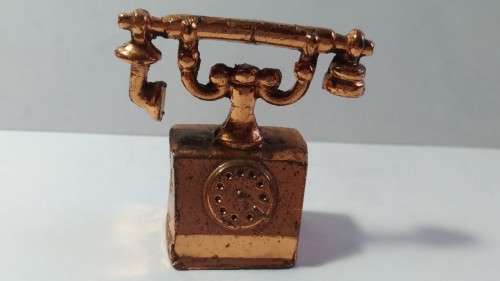 Miniature copper old style telephone