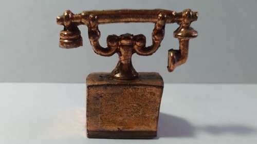 Miniature copper old style telephone