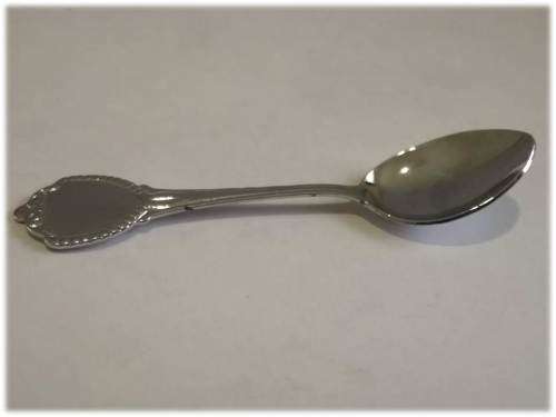 Miniature silver tone plastic spoon