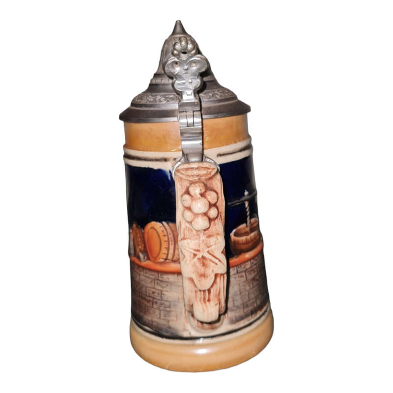 Vintage German ceramic beer mug with a hinged pewter lid.