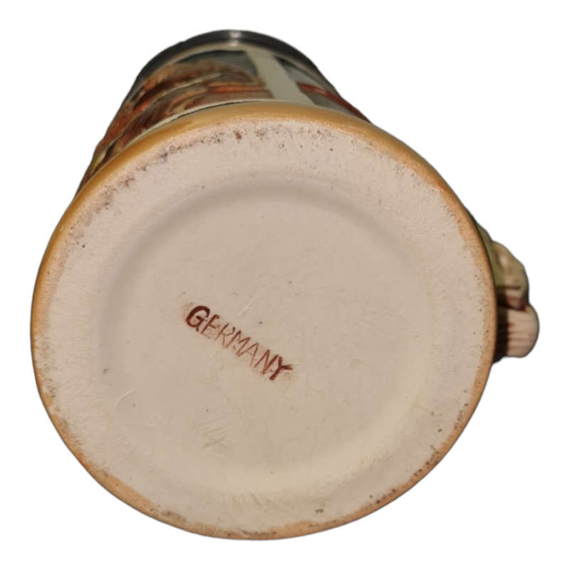 Vintage German ceramic beer mug with a hinged pewter lid.