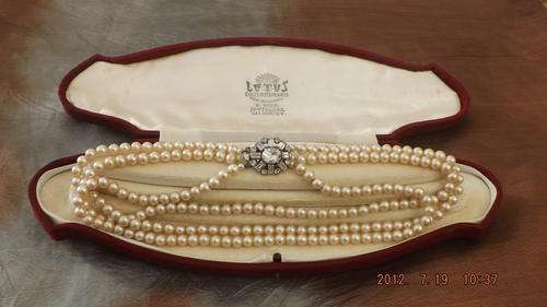 FABULOUS TRIPLE STRAND OF VINTAGE FAUX PEARLS.