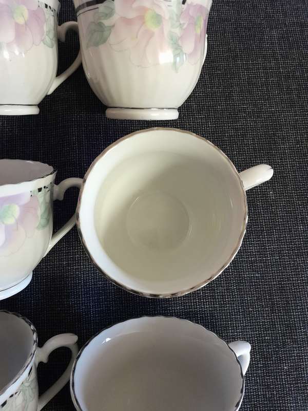 6 Floral porcelain tea cups with silver trim New