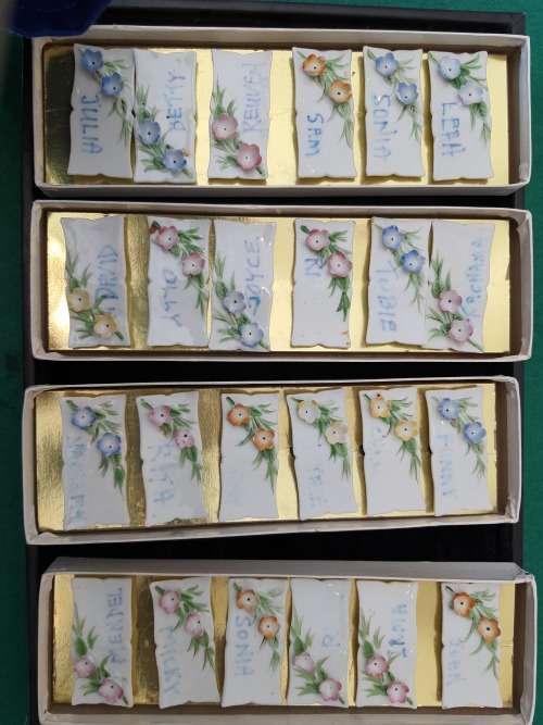 4 sets of 6 each in a box Nameplates made of porcelain and floral decorated
