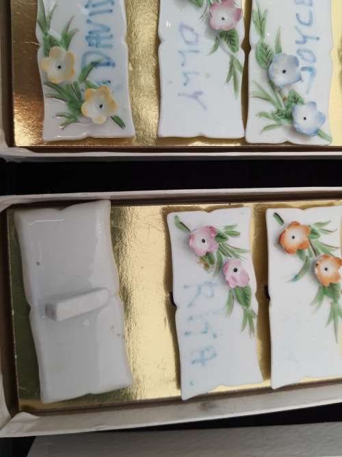 4 sets of 6 each in a box Nameplates made of porcelain and floral decorated
