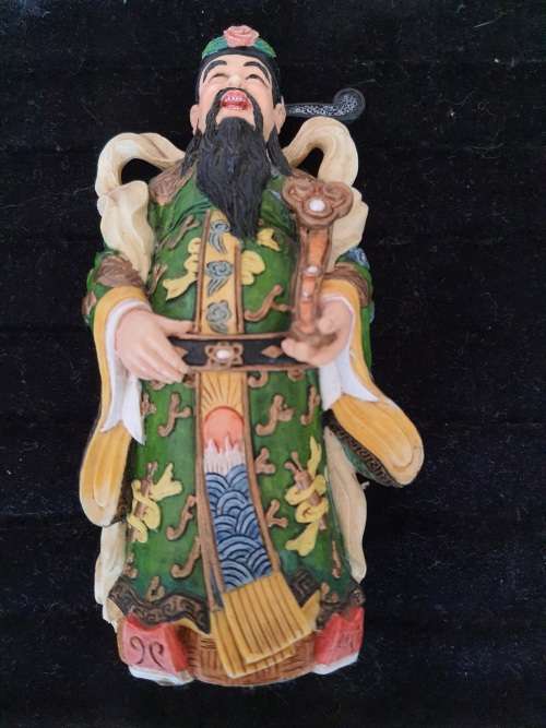 A CHINESE FIGURINE LOOKS LIKE THE PHILOSIPHER CONFUSCIOUS WITH A PIECE OF HIS HAT MISSING