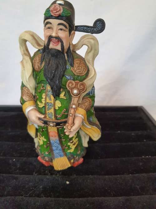 A CHINESE FIGURINE LOOKS LIKE THE PHILOSIPHER CONFUSCIOUS WITH A PIECE OF HIS HAT MISSING