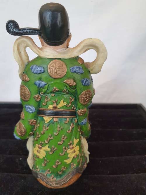 A CHINESE FIGURINE LOOKS LIKE THE PHILOSIPHER CONFUSCIOUS WITH A PIECE OF HIS HAT MISSING