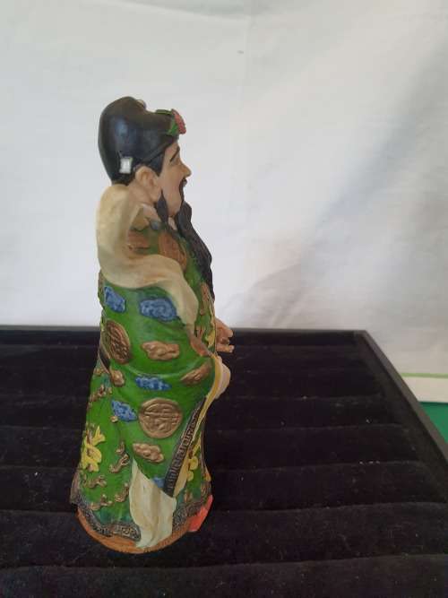 A CHINESE FIGURINE LOOKS LIKE THE PHILOSIPHER CONFUSCIOUS WITH A PIECE OF HIS HAT MISSING
