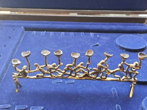A VINTAGE MENORAH BRASS MADE IN JERUSALEM APPROXIMATELY 520 GRAMS