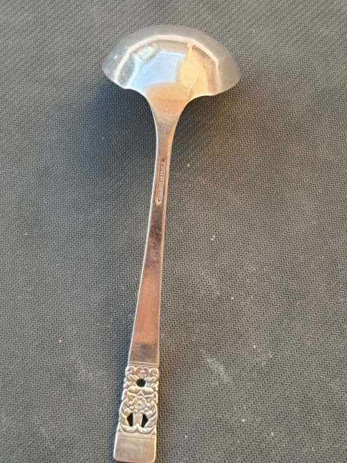 A SILVER PLATED SOUP LADEL IN PERFACT CONDITION STAMPED COMMUNITY
