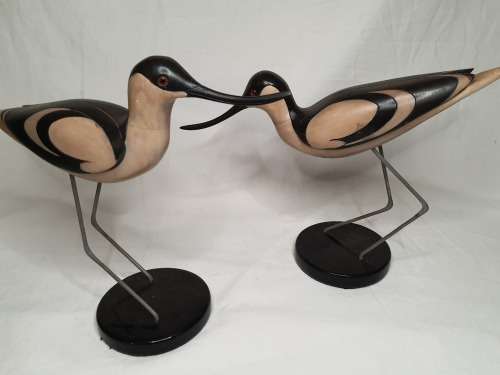 A LIMITED EDITION PAIR OF AVOCET CARVED WOODEN FIGURINES