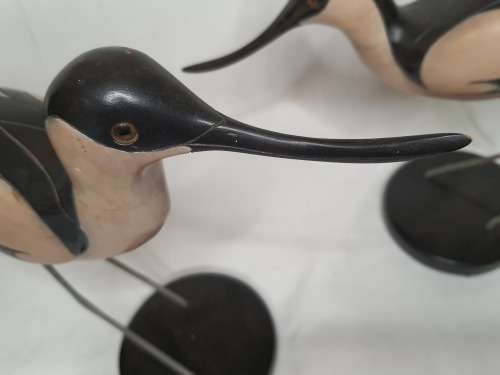A LIMITED EDITION PAIR OF AVOCET CARVED WOODEN FIGURINES