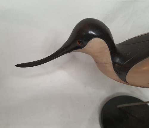 A LIMITED EDITION PAIR OF AVOCET CARVED WOODEN FIGURINES