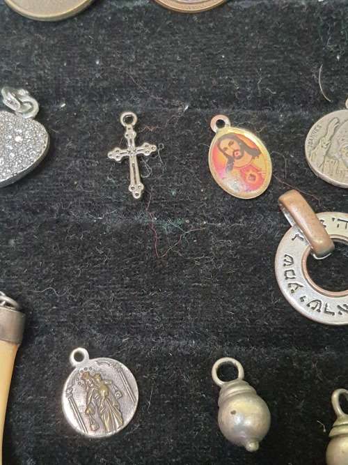 A VINTAGE COLLECTION OF PENDANTS SOLD AS IS