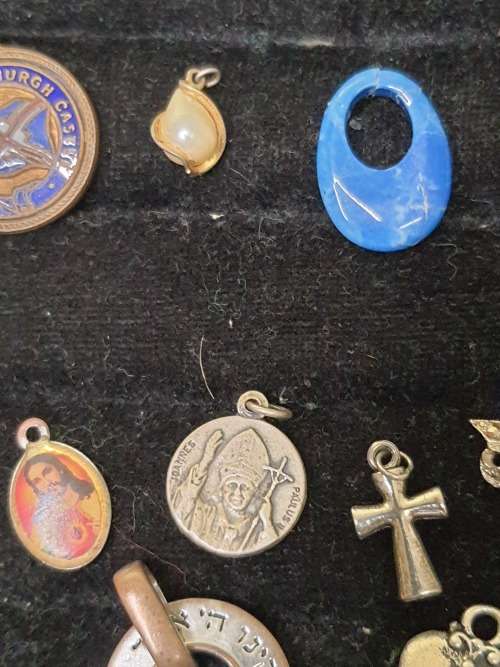 A VINTAGE COLLECTION OF PENDANTS SOLD AS IS