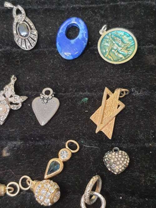 A VINTAGE COLLECTION OF PENDANTS SOLD AS IS