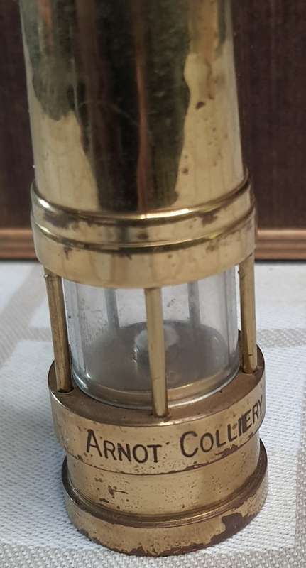 AN ORNAMENTAL BRASS OIL LAMP SOLD AS IS