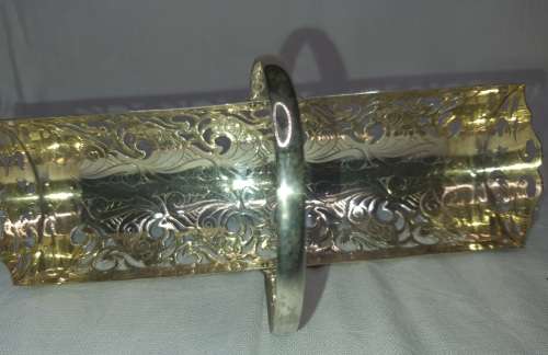 A VINTAGE SILVER PLATED BISCUITE BASKET SOLD AS IS