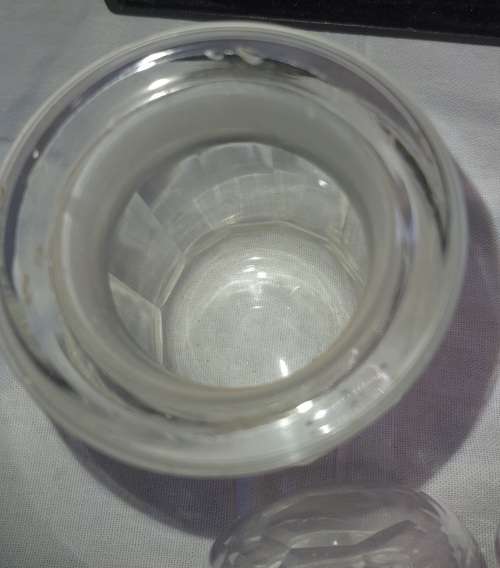 A SET OF 2 STORAGE GLASS BOTTLE CONTAINERS THE ONE LID WAS REPAIRED BEFORE SOLD AS IS