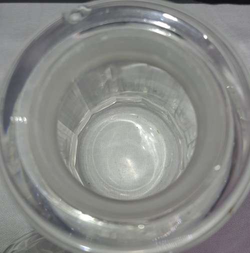 A SET OF 2 STORAGE GLASS BOTTLE CONTAINERS THE ONE LID WAS REPAIRED BEFORE SOLD AS IS