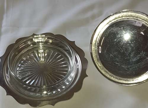 A VINTAGE BUTTER DISH EPNS WITH A CRYSTAL BOWL AND A LID SOLD AS IS